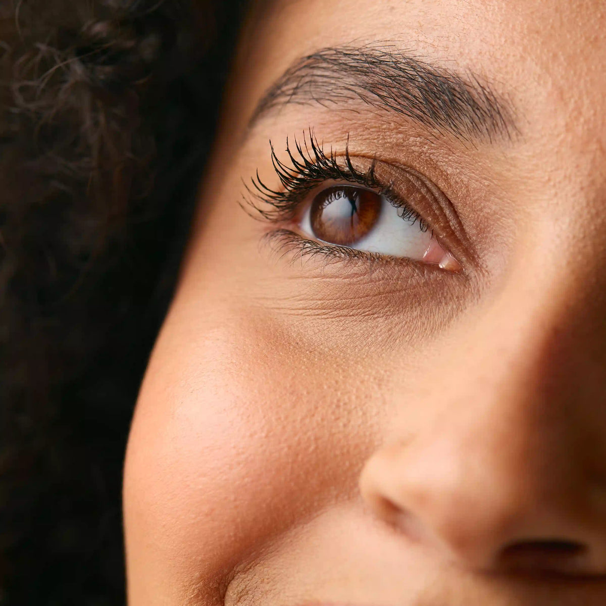 Close-up of the delicate under-eye area and its natural fine lines, the focus of a gentle, needle-free under-eye routine.