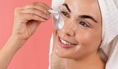 Applying Opuola hydrogel under-eye patch during skincare routine