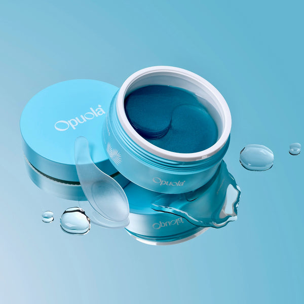Blue jar of Opuola eye care patches open on a light blue background 