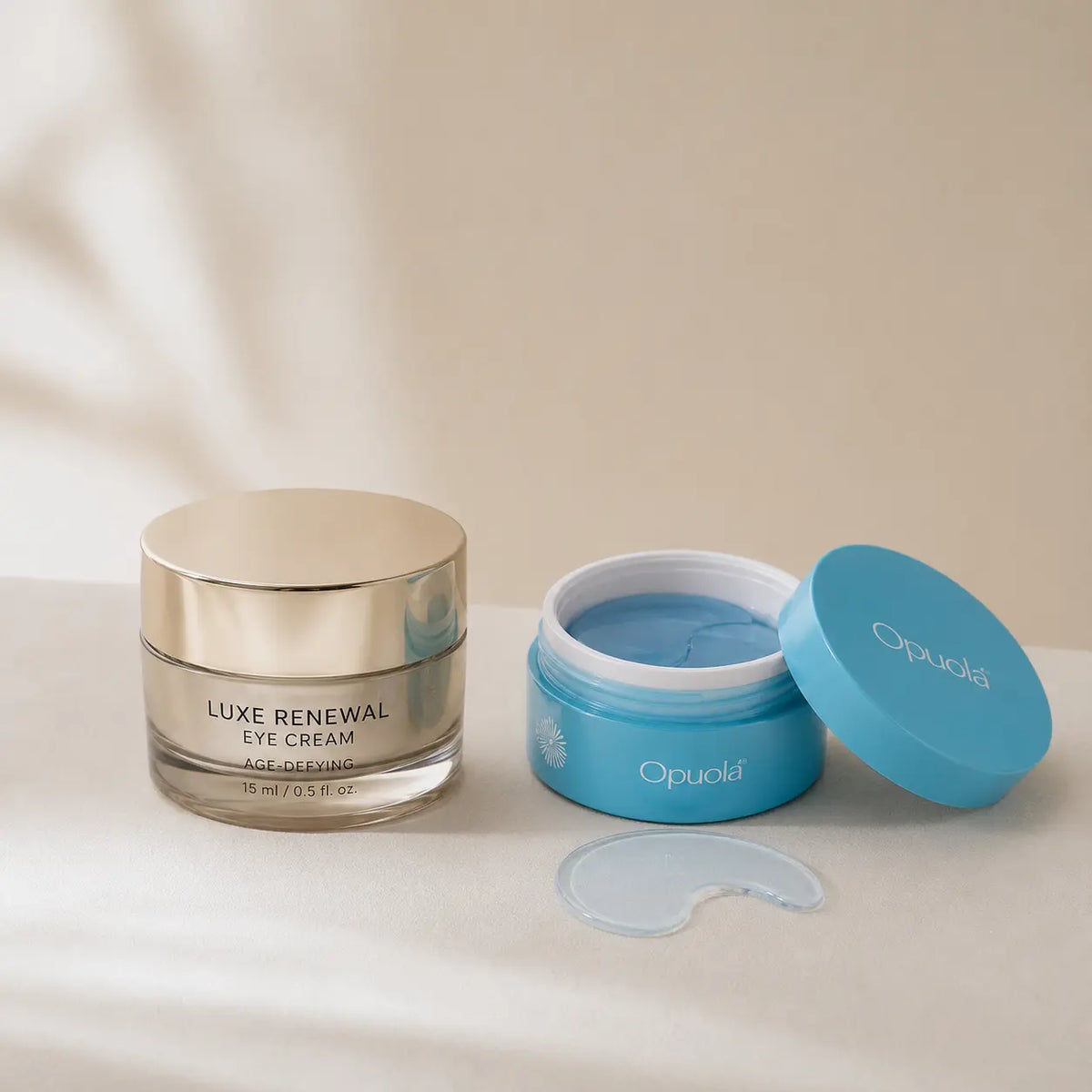 An eye-cream jar next to blue hydrogel under-eye patches illustrating under-eye wrinkle myths versus reality